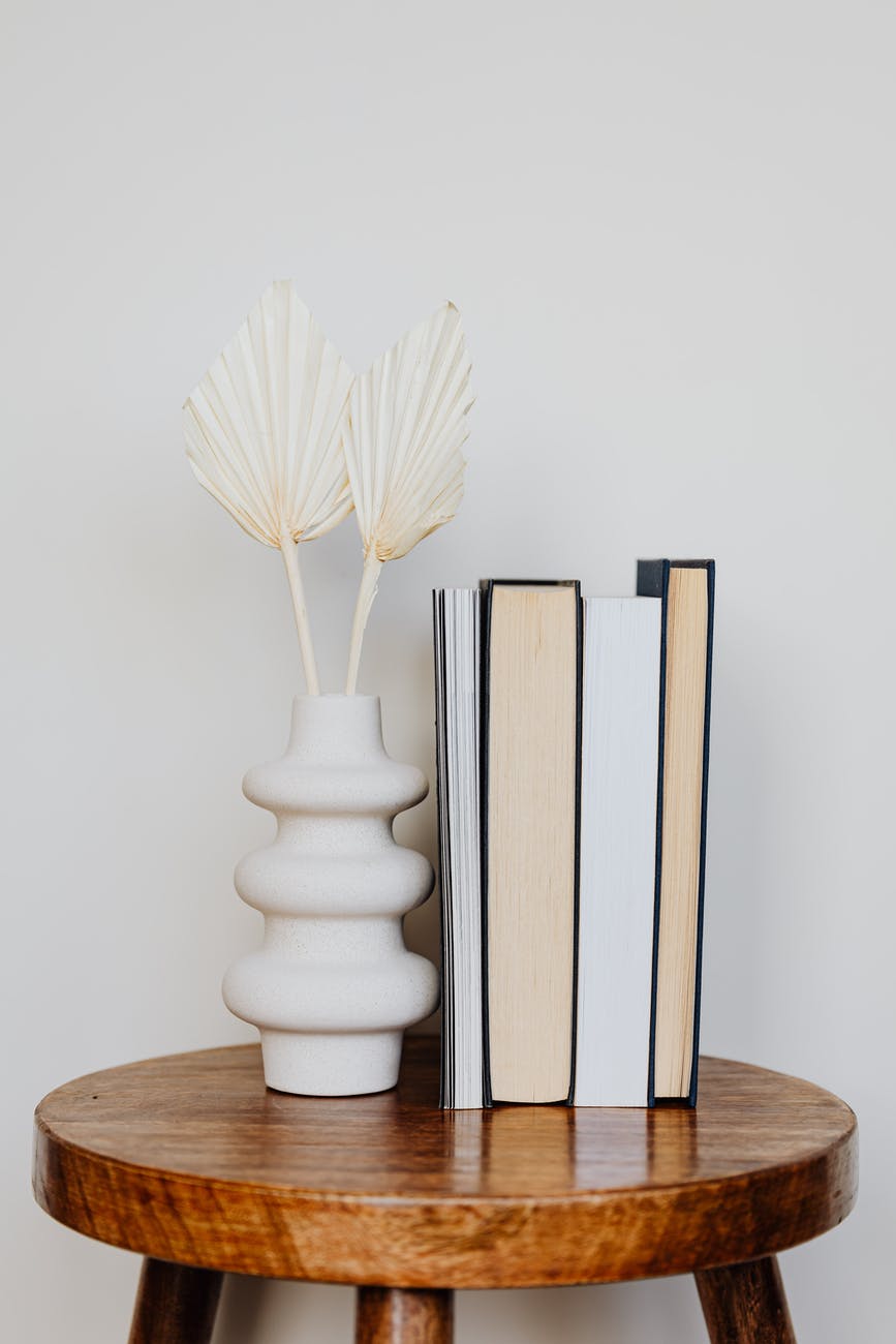 original vase and stack of books on table