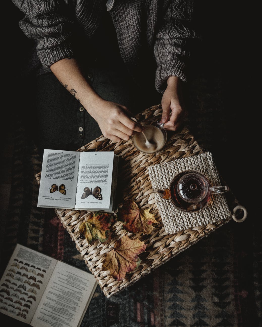 crop person with book and coffee