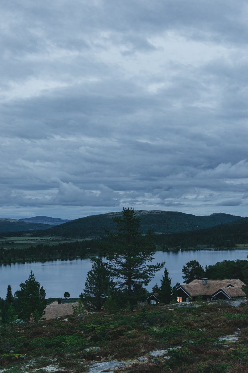 calm lake and houses in mountainous valley